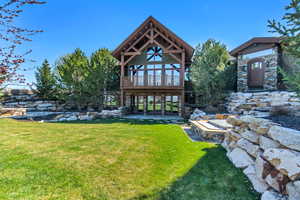 Back of property with a yard and a patio