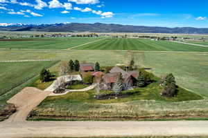 Aerial view of sparsely populated area with agricultural land and a mountain backdrop