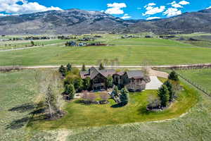 Aerial view of sparsely populated area featuring agricultural land and mountains