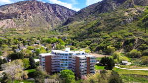 Drone / aerial view of a mountain backdrop and building