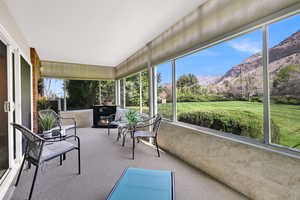 Sunroom featuring a mountain view