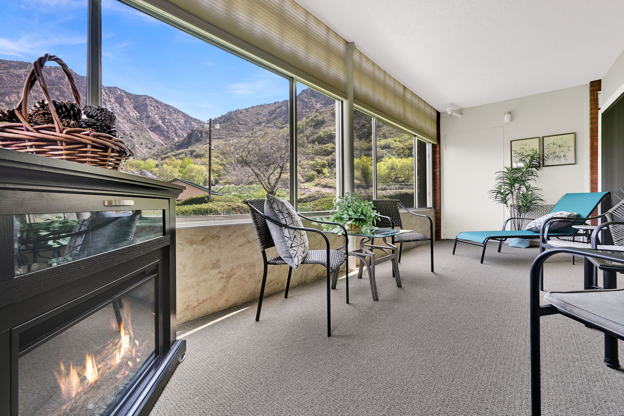 Sunroom / solarium with a mountain view and a glass covered fireplace