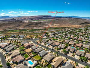 Aerial perspective of suburban area featuring a mountain backdrop