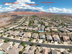 Aerial perspective of suburban area with a mountainous background