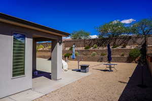 Fenced backyard with a patio area