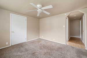 Unfurnished bedroom featuring carpet and a ceiling fan