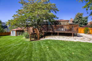 View of back down to lower patio with included gazebo covering hot tub. East side has room for RV pad