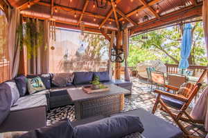 Huge wooden deck, and an outdoor lounge area with included gazebo. Views & shade trees add to the wonder