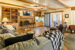 This is a large comfortable room with beamed ceiling and custom cabinetry. Shows french doors to huge deck