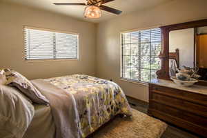 Bedroom #3 with dark wood finished floors and ceiling fan. Lots of light with valley and mountain views