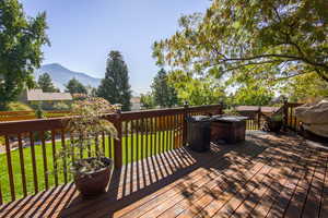 Wooden terrace with a yard, a mountain view. Back fence has double gate to access common park area and walking paths. May be used for vehicle access