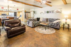 Reverse view of great room. Also showing tiled entry off of garage access. Family room to dining with full size table