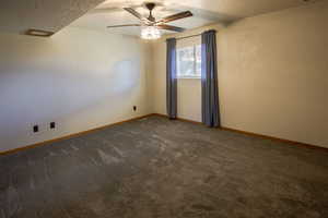 4th bedroom, has above ground window to backyard, ceiling fan and mirrored closet doors