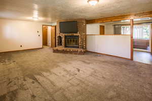 The downstairs fam room has Fp w/gas insert. Separated space is pot. kitchen. Slider leads to covered patio w hot tub