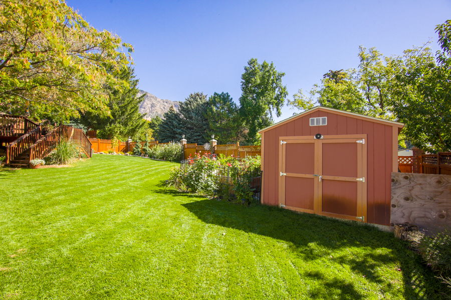 View of backyard from west side. Good size garden with raised beds with fencing. Garden shed. Open space back