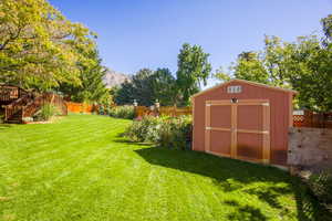 View of backyard from west side. Good size garden with raised beds with fencing. Garden shed. Open space back