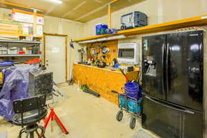 Extra deep, 2 separate doors &openers, has gas heating, shelving, cabinets, workbench & man door to side yard