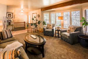 Formal tiled entry. Stairs for downstairs living. Step down into large formal living room with carpet.