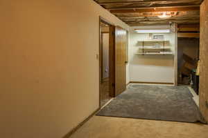 Good sized unfinished space for utility access. Room has shelving and storage cabinets