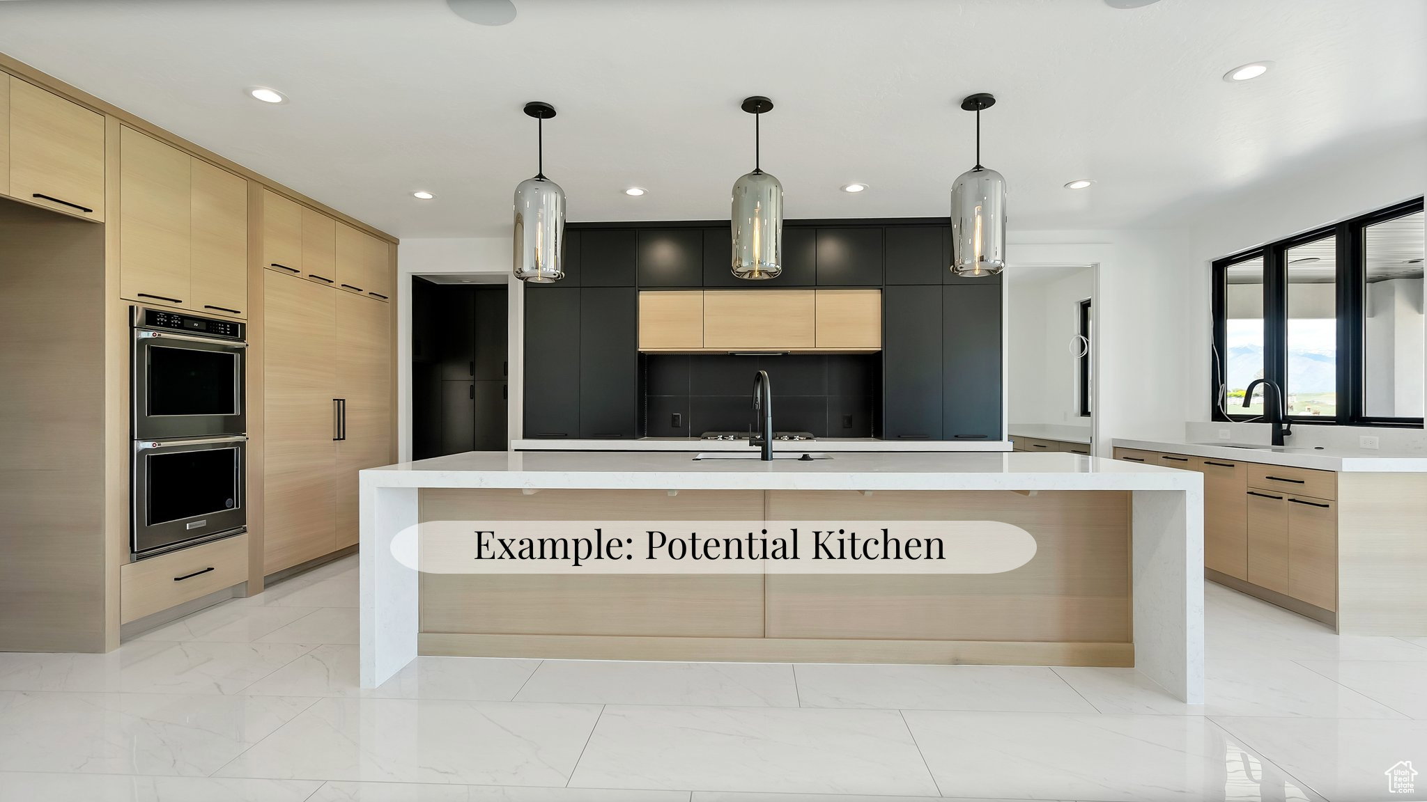 Dual tone kitchen featuring modern cabinets, a kitchen island with sink, pendant lighting, double oven, and two tone cabinetry