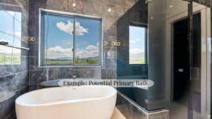 Bathroom featuring tile walls, a freestanding bath, and a shower stall