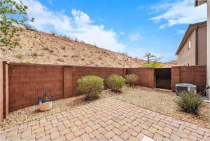 Fenced backyard with a patio area and a mountain view