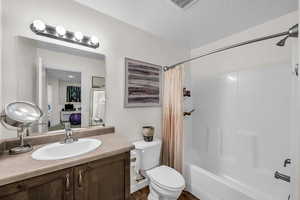 Bathroom featuring vanity and shower / tub combo with curtain