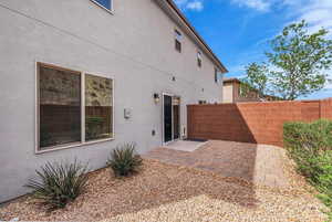 Back of property with a patio, a fenced backyard, and stucco siding