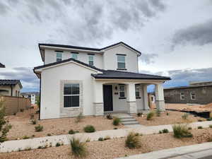 View of front of home with covered porch, stucco siding, a tiled roof, and stone siding