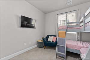 Bedroom featuring baseboards and light colored carpet