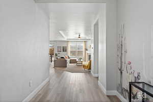 Hallway with light wood finished floors and baseboards