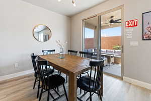 Dining area with light wood-type flooring and a ceiling fan