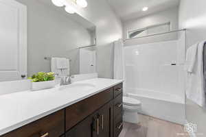 Bathroom with vanity and shower / bath combo with shower curtain