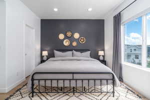 Bedroom featuring baseboards and an accent wall