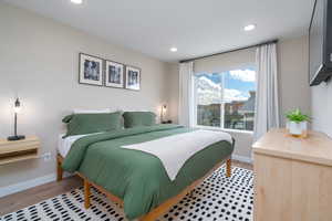 Bedroom with light wood-style floors and recessed lighting