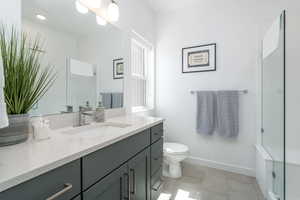 Bathroom with vanity, a stall shower, and light tile patterned floors