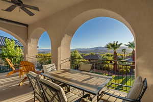 View of patio / terrace with outdoor dining space, a ceiling fan, and a mountain view