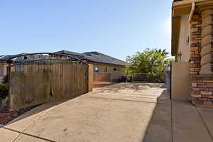 View of side of home with a gate
