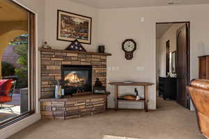 Living room with a fireplace and light carpet