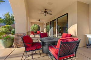 View of patio featuring a ceiling fan and an outdoor fire pit