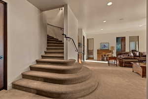 Stairway with carpet and recessed lighting