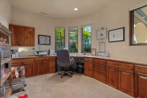 Office space featuring carpet floors and recessed lighting