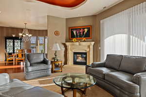 Living area featuring a glass covered fireplace and suspended lighting