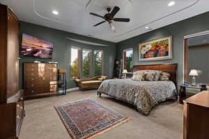 Bedroom with a ceiling fan, light carpet, and recessed lighting
