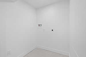 Laundry area featuring hookup for an electric dryer and washer hookup