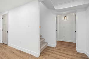 Staircase with baseboards and wood finished floors
