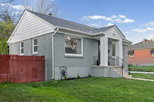 Bungalow-style home with brick siding