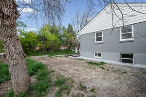 View of side of home with a patio and brick siding
