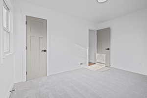 Unfurnished bedroom with baseboards and carpet