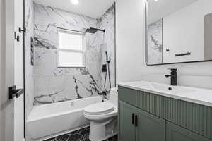 Full bathroom with vanity and a combined bath / shower with marble appearance
